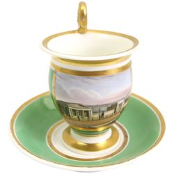 19th century French Empire design porcelain cup and saucer, the cup hand painted with a panel, titled beneath 'Library, St Leonards, Near Hastings', against a green and gilt ground, cup H10.5cm 