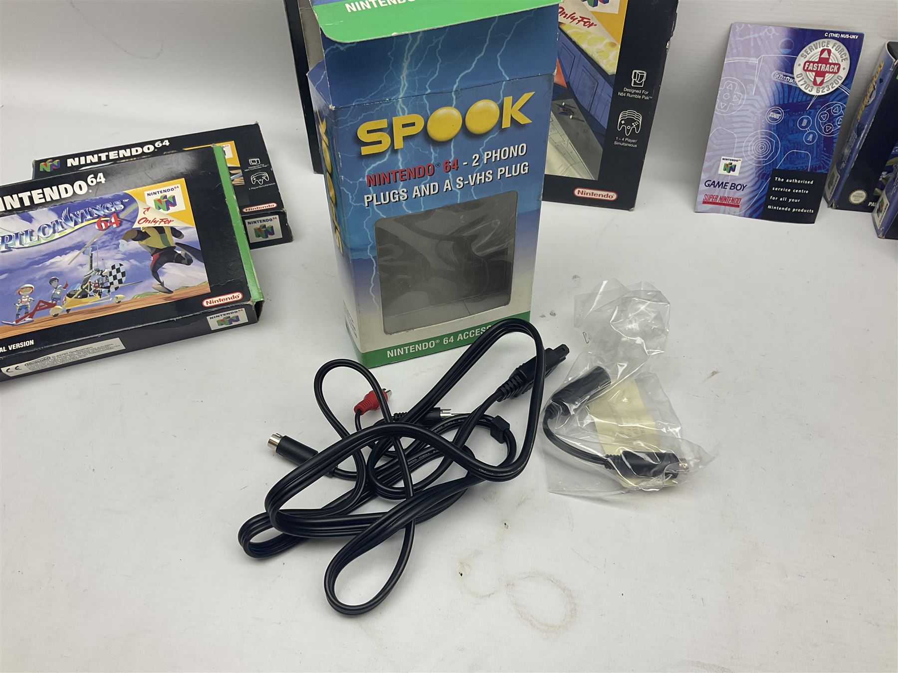 Nintendo 64 console, two controllers, games and accessories. Accessories to include the ‘Tremorpak’ and ‘Spook’ 2 Phono plugs and a S-VHS plug with adapter, both in original boxes. Games to include ‘Golden Eye 007’, ‘Doom 64’, ‘Killer Instinct Gold’, ‘Tetrisphere’, ‘F-1 World Grand Prix’, ‘Pilotwings 64’ and ‘Lylatwars’ with ‘Rumble Pak’, all with original boxes and instruction manuals. ‘Star Wars Episode I Racer’ game cartridge in Shadows of the Empire box. 