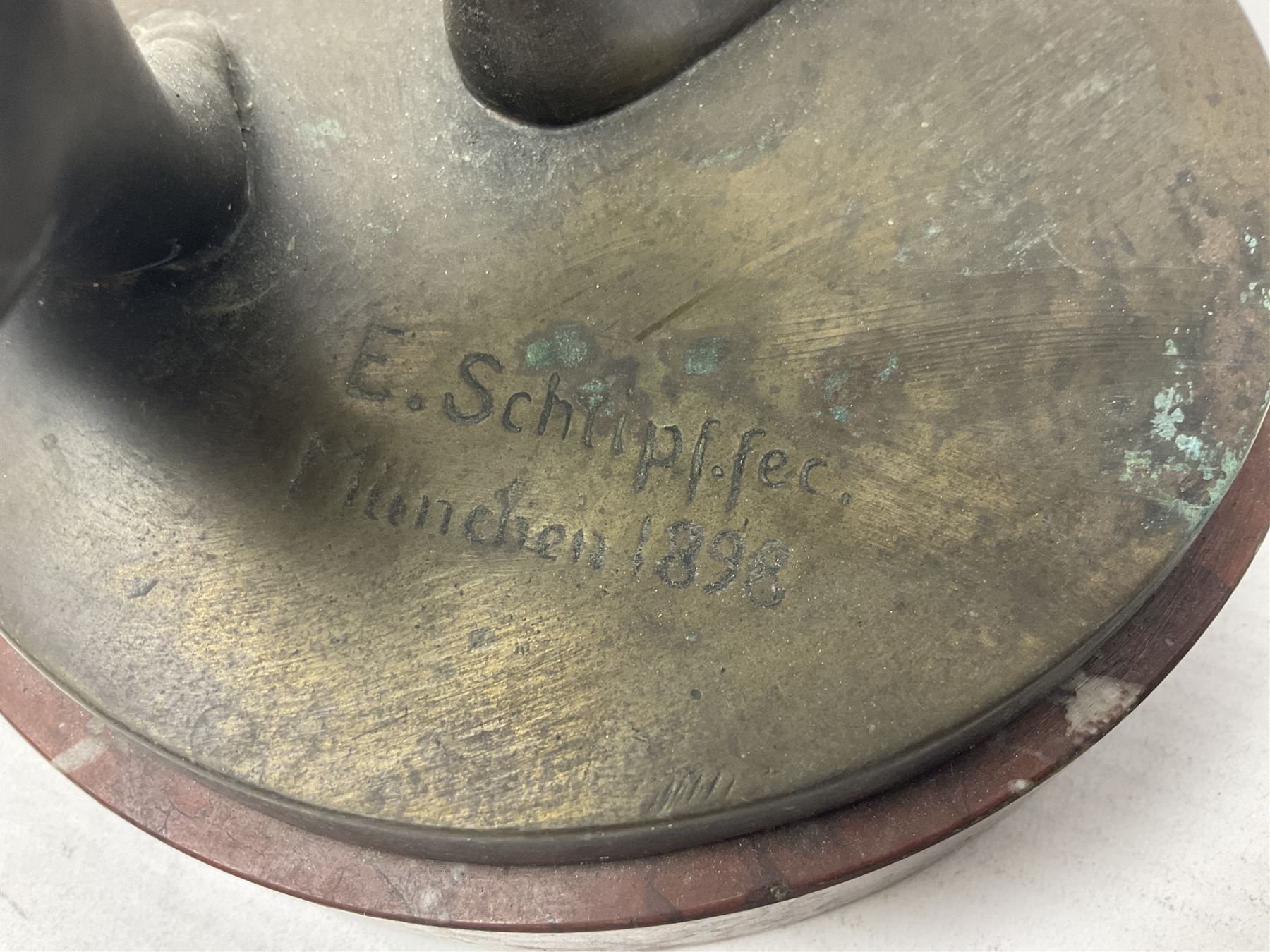 After Eugen Schlipf, Fanfair, bronzed female figure playing two horns, upon a circular marble plinth, H57cm