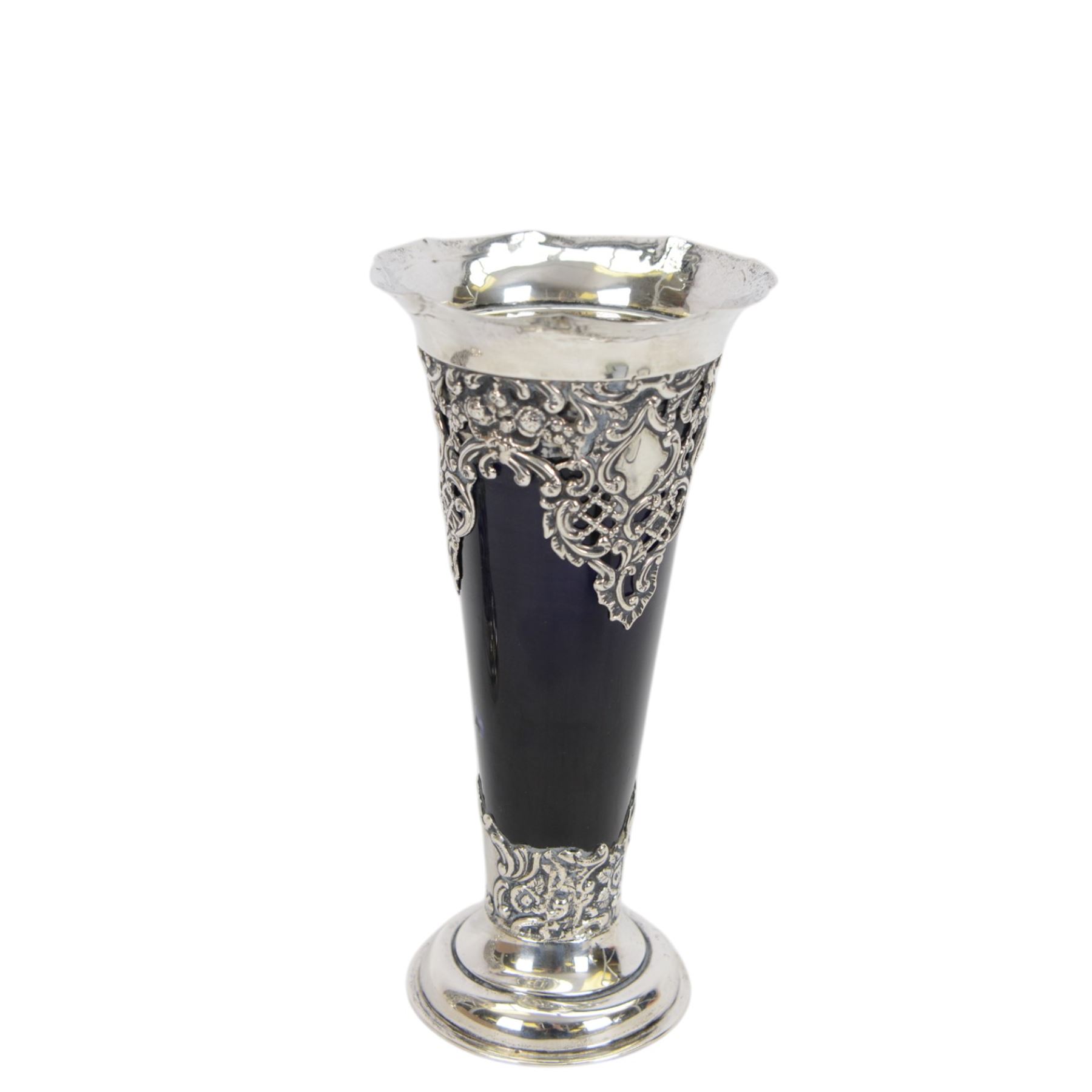 Two late Victorian silver mounted vases, including blue glass mounted example with fluted rim and upon circular foot, hallmarked Henry Matthews, Chester 1900 and a tapering example with fluted rim and pierced embossed scroll decoration to body, with blue glass liner, hallmarked James Deakin & Sons, Chester 1897, tallest H18.5cm