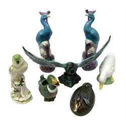 Blue Mountain Pottery style figure modelled as an eagle perched upon a rocky base with outstretched wings in blue green glaze, W36cm, together with pair of blue and purple peacock figures and other duck and bird ceramic animal figures