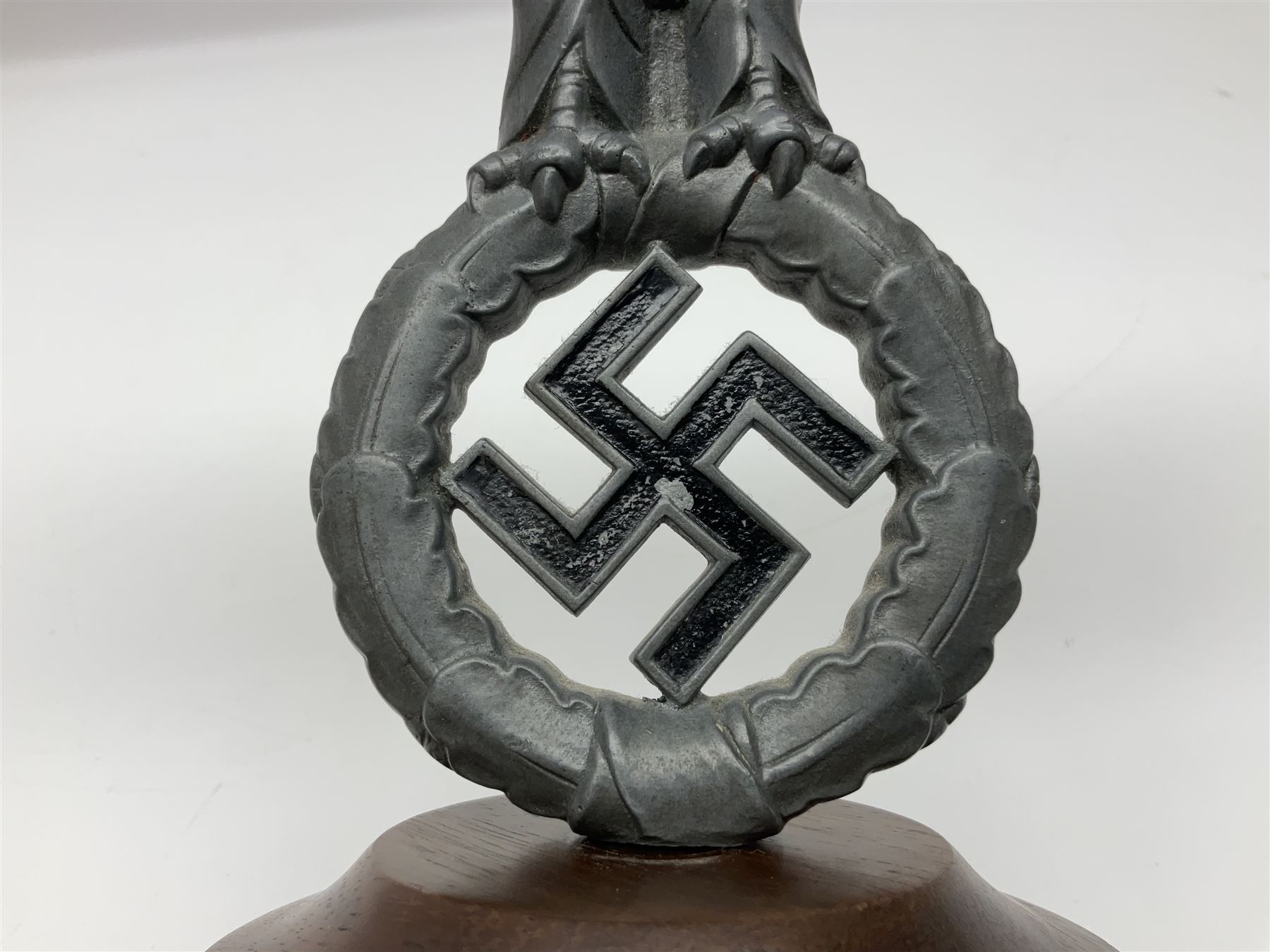 WW2 German cast white metal desk ornament/paperweight as the eagle insignia on later turned mahogany plinth H22cm