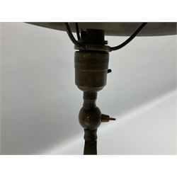 Arts & Crafts Jesson, Birkett & Co, brass table lamp or wall light, designed by Thomas Birkett, the tapering stem with adjustable ball pivot supporting a conical shade with tapering final with ball terminal, upon a circular domed base pierced for wall mounting, shade positioned upright overall H57cm

Often misattributed to Arthur Stansfield Dixon for Birmingham Guild of Handicraft, this particular lamp was designed by Thomas Birkett.
In the late 1890's Birkett worked as a metalwork at the Birmingham Guild, before later joining the Faulkner Bronze Company which went on to become Jesson, Birkett & Co in 1904. The lamp features in lighting catalogues from the firm under the model no E490.

