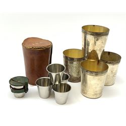 A silver plated set of four stirrup cuts with gilded interiors, by P H Vogel & Co, in brown leather case tooled in gilt J.R.S., each cup marked beneath P.H.V&Co Silver Plated Made in England, H8.5cm D7.5cm, together with a set of six stainless steel Swedish stirrup cups by Rostfritt, in green leather holder, each cup marked beneath Rosfritt, H4.5cm D5cm.