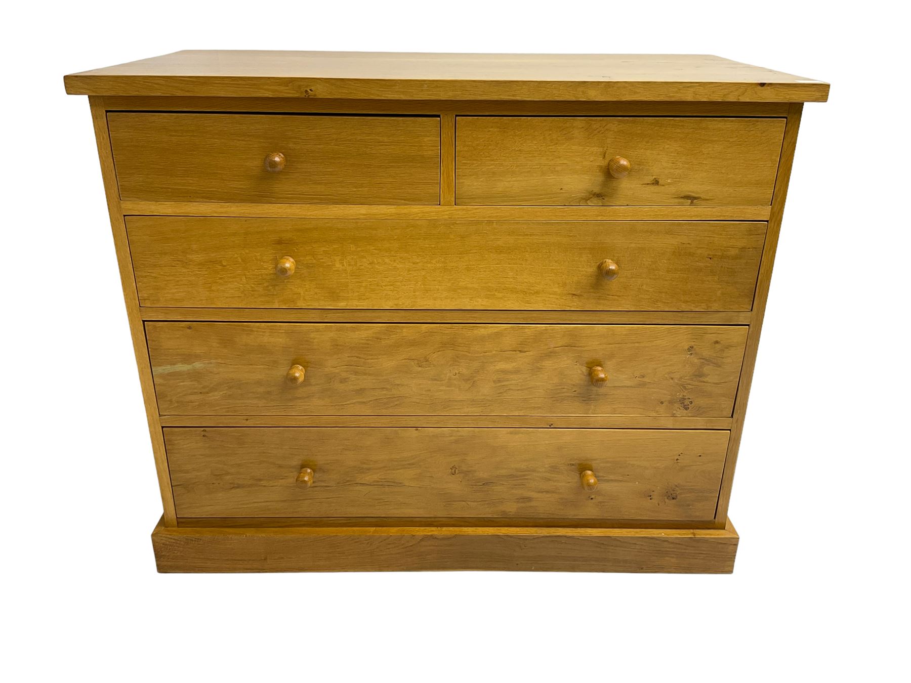 Craftsman made light oak chest, fitted with two short and three long drawers, on plinth base