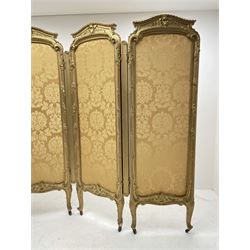 Late 19th/early 20th century French Rococo style gilt wood and gesso dressing screen, four double hinged panels, each with shaped cresting rail over shell and floral frieze, moulded frame with flower head and scroll decoration, acanthus leaf cabriole supports with castors, upholstered in gold Damask fabric