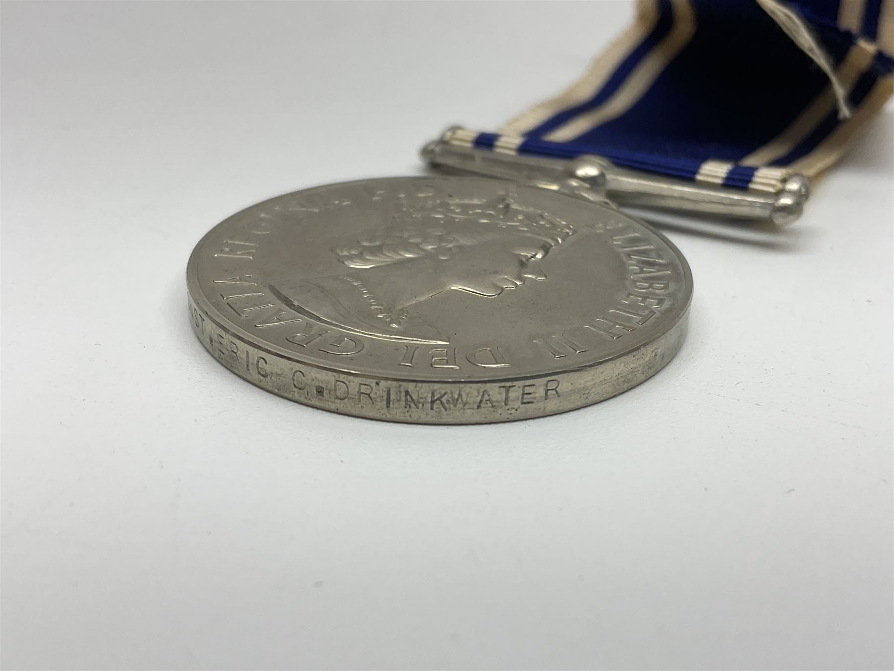 Collection of WW2 and police medals c.1933-1955, awarded to Eric Drinkwater comprising 1939-45 War Medal, Defence Medal, 1939-45 Star and Burma Star, on wearing bar; 1918-62 General Service Medal with Cyprus clasp to P.S. E.G. Drinkwater; boxed; Police Long Service and Good Conduct Medal to Const. Eric C. Drinkwater; cased; Royal Life Saving Society bronze medal to E.C. Drinkwater July 1933; boxed; and George V 1937 coronation medallion; boxed.