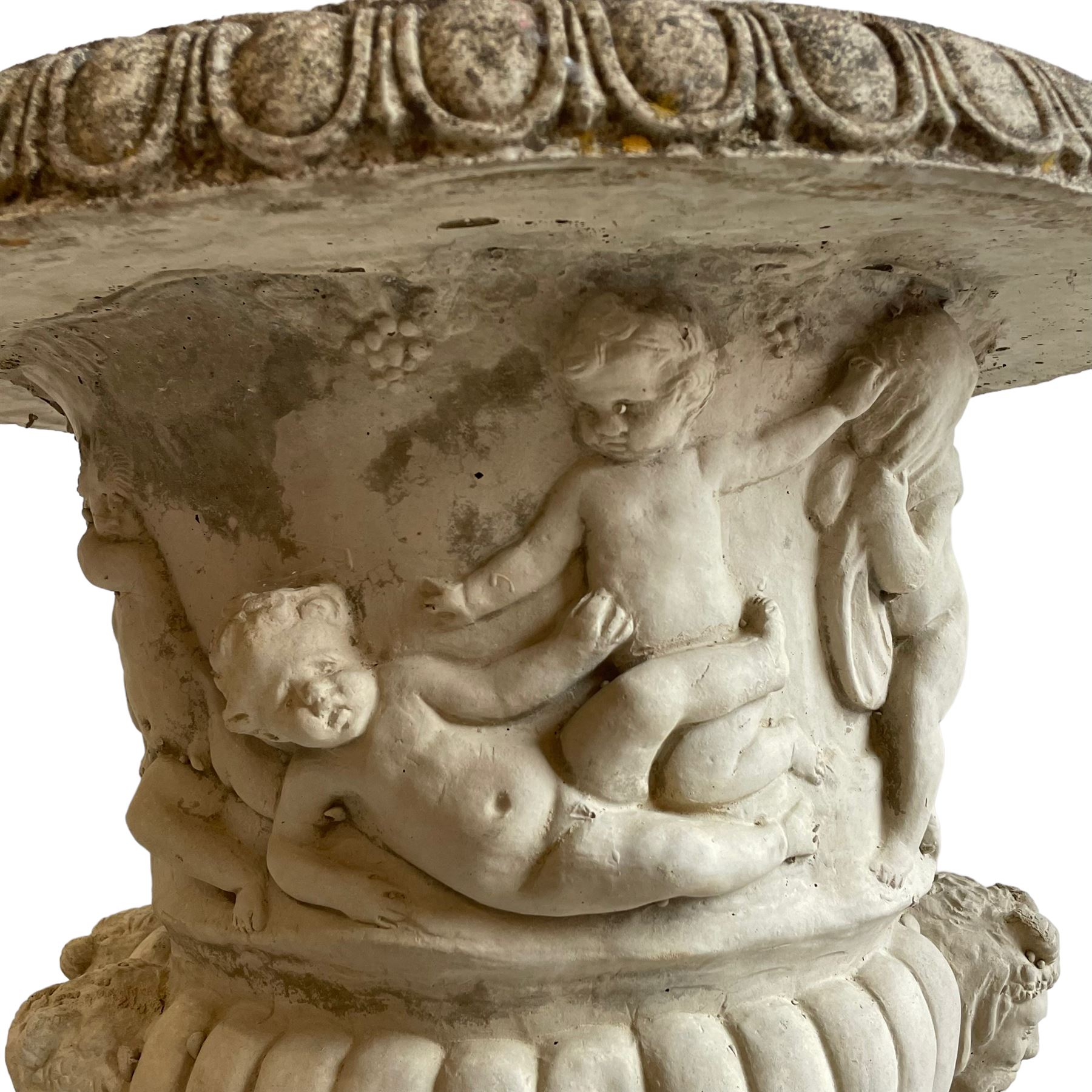 Large pair of cast stone three-piece Grecian urns, the moulded rim over body decorated with putti, horses and trees, gadrooned underbelly with faun masks, on stepped and moulded circular footed base, the square plinth with moulded upper edge, each side decorated with laurel wreath, moulded skirted base