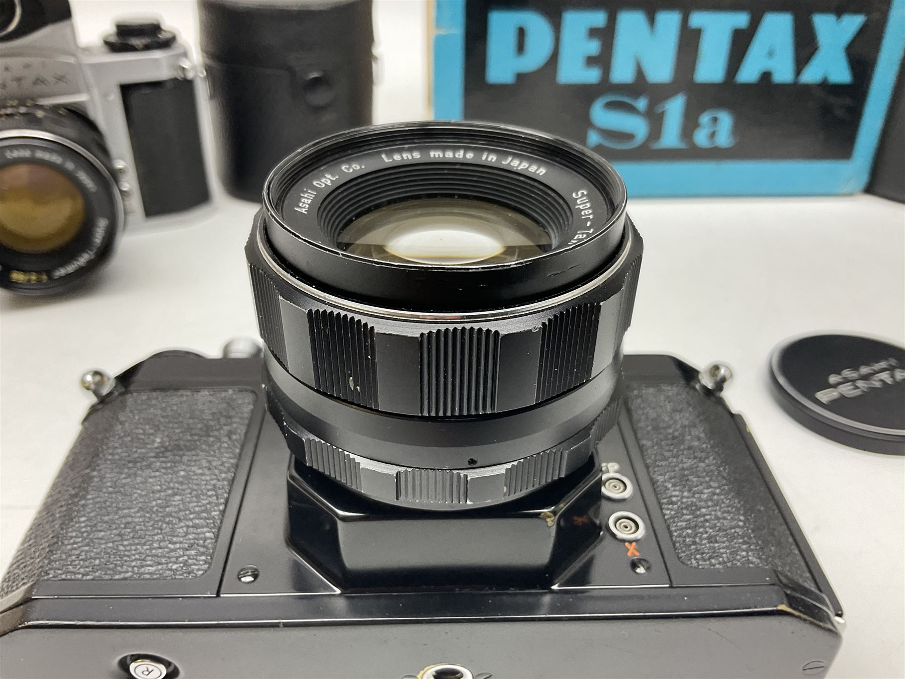 Asahi Pentax S1a camera body, serial no. 707071, with 'Super-Takumar 1:1.8/55' lens, serial no 2124044, together with Asahi Pentax Sv camera body, no. 1925617 with 'Super-Takumar 1:2/55' lens, serial no. 2770153, Asahi Pentax Meter, 'Super-Takumar 1:3.5/28' lens, serial no. 2075492 and 'Super-Takumar 1:4/150' lens, serial no. 1461613  
