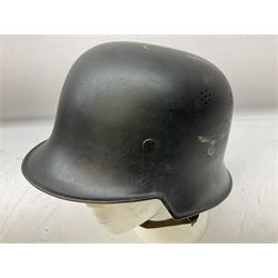 WW2 German steel combat helmet with eagle insignia to one side and U-724 to the other, leather liner marked No.56 and leather chin strap; indistinctly stamped to the skirt '*ahl'