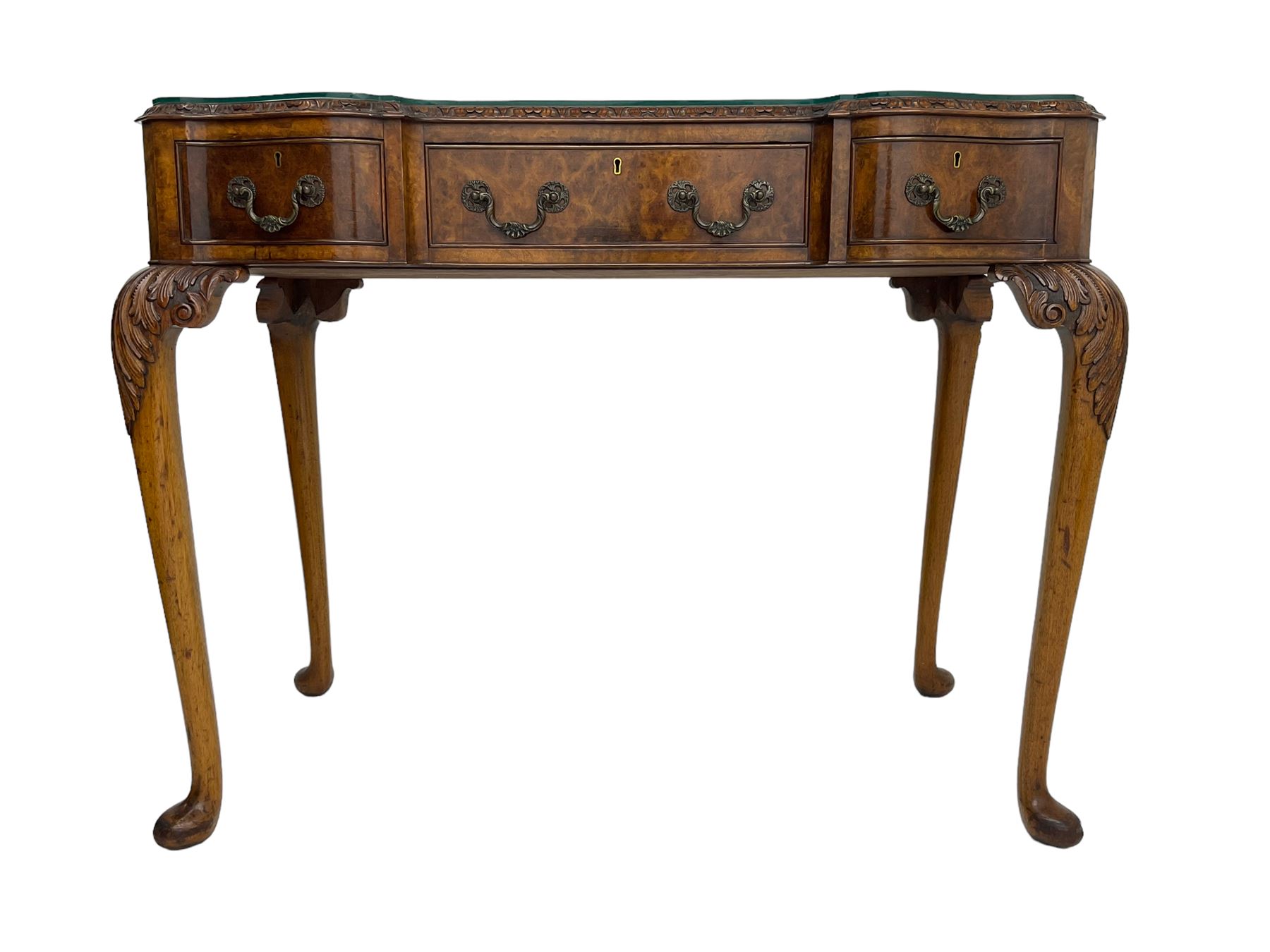 Early 20th century Queen Anne design walnut reverse break-front console side table, edge carved with acanthus decoration, fitted with three cock-beaded drawers, raised on cabriole supports with applied carved scrolling foliate decoration