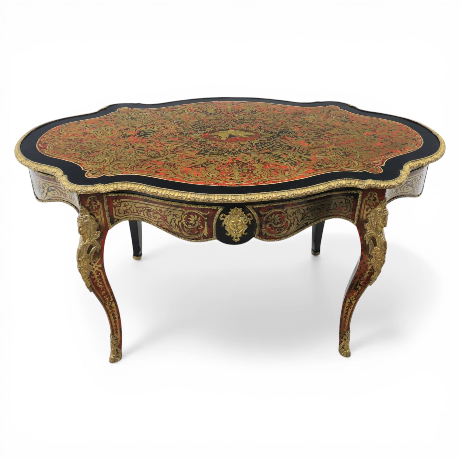 Late 19th century boulle work centre table, shaped serpentine top decorated with brass inlay on red tortoiseshell ground within ebonised border, fitted with single frieze drawer, on cabriole supports with gilt metal mounts and mask terminals