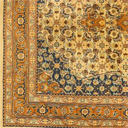 Persian Bijar rug, ivory field profusely decorated with a dense all-over Herati pattern centered by a red medallion with indigo lozenge and spandrels framed by a rust ground border of stylized palmettes and rosettes, between narrow floral guards