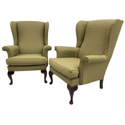 Pair of late 20th century hardwood-framed wingback armchairs, upholstered in green and gold fabric, on cabriole front feet 