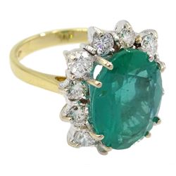 18ct gold oval emerald and round brilliant cut diamond cluster ring, hallmarked, emerald approx 5.90 carat, total diamond weight approx 1.40 carat