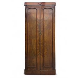 Victorian figured walnut single wardrobe, the moulded cornice with a central diamond motif over a pair of arched panelled doors with striking book-matched veneers, enclosing a fitted interior with hanging rail and hooks, on a plinth base