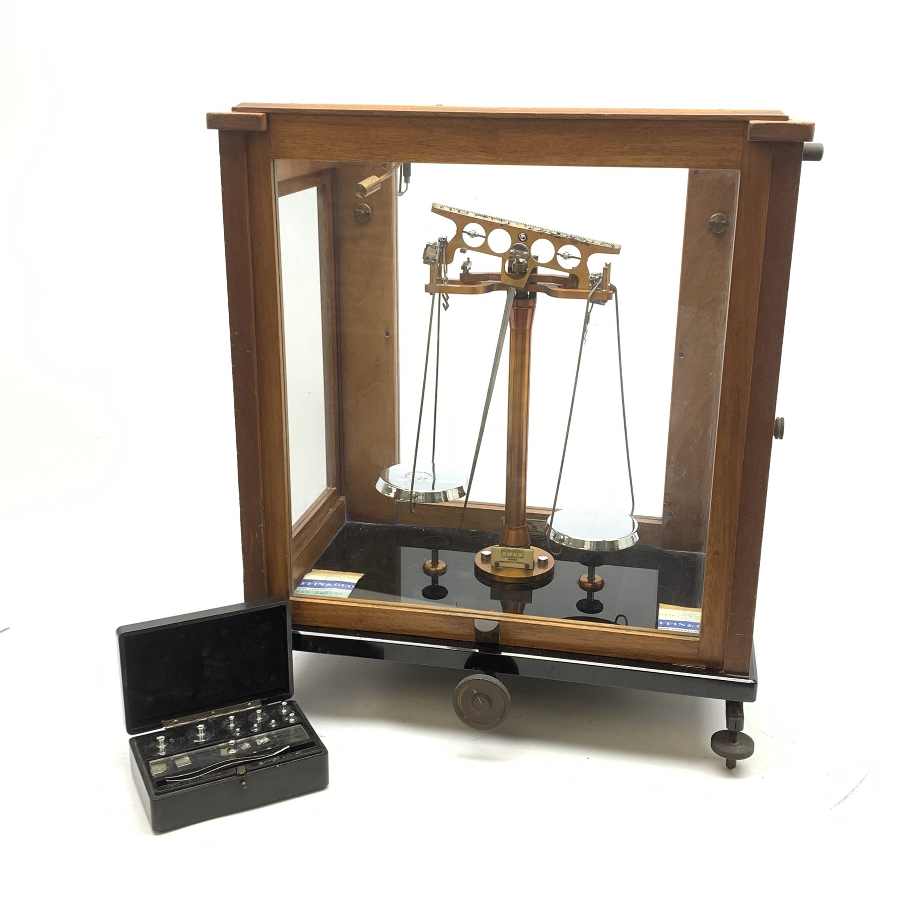 Set of cased brass and chrome laboratory scales by J.W. Towers Widnes Model 75, with black vitrolite type base, upward sliding front and hinged side doors, W40cm H47cm; with bakelite cased set of weights by ETA Instruments Ltd