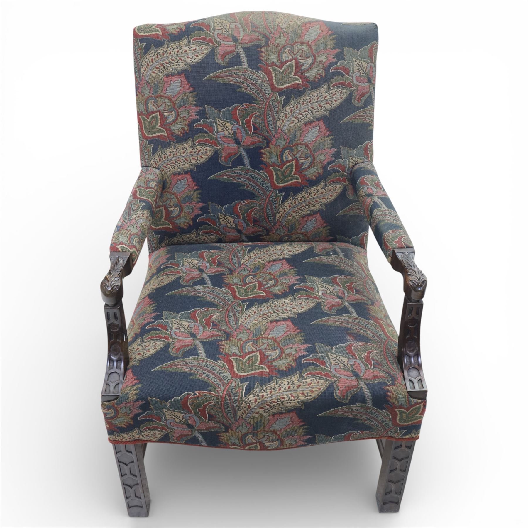Early 20th century Chippendale revival Gainsborough elbow chair, rectangular upholstered back and seat covered in foliate patterned fabric, with open arms carved to the terminals and supports with pierced and geometric detail, raised on square section legs with blind fretwork panels
