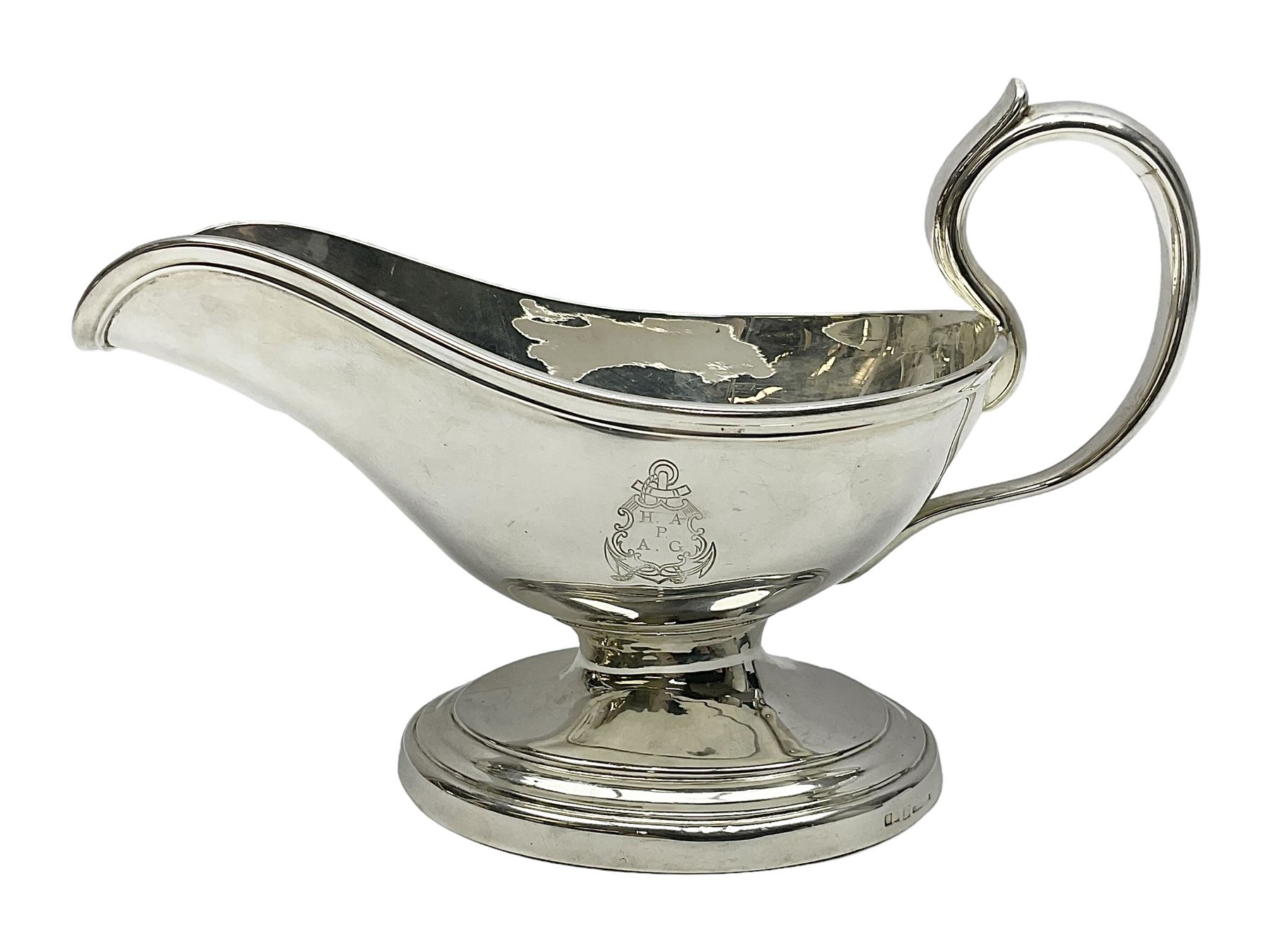 Christofle silver-plated sauce boat, of typical plain form, with capped C scroll handle and engraved anchor crest to body, upon a stepped oval foot, stamped 22 Christofle to base, including handle H14cm