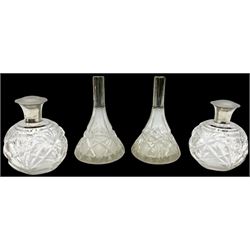Pair of silver collared and lidded perfume bottles of bulbous form together with a pair of silver collared scent bottle of conical form, all hallmarked but worn and indistinct, tallest example H17cm 