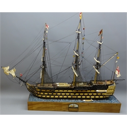  Wooden solid hull scale model of HMS Victory, furl rigged flying signal flags, with lifeboat on stand with ocean textured top, built c1990, with photos of build, plans and 1vol Anatomy of The 110 Gun Ship Victory by John McKay, L104cm, H77cm  