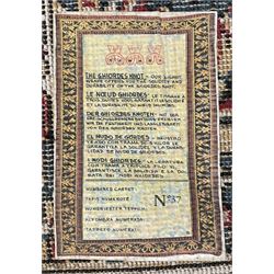 Persian design rug, rectangular crimson ground field with medallion, surrounded by trailing foliate branches, within wide border bands decorated with stylised floral motifs 