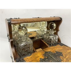 Victorian oak tantalus, mirrored high-back with recess for housing the decanters, behind a hinged box, with cribbage board to the concealed drawer below, marked Barman, London, H33cm, L37cm