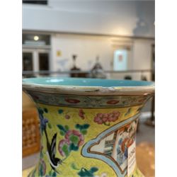 19th century Chinese famille rose yellow ground porcelain vase, of baluster form with twin applied mask ring handles, the body decorated with two shaped reserves mounted with dragon heads, depicting warriors at battle and at court, the neck with two smaller conforming figural reserves, upon a yellow ground decorated with exotic birds amidst scrolling blossom, H45.cm