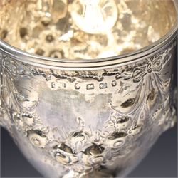 Victorian silver cup with embossed decoration on a plastic base, height of cup 16cm Birmingham 1868 and a small silver challenge cup 'Whitby Show 1950'