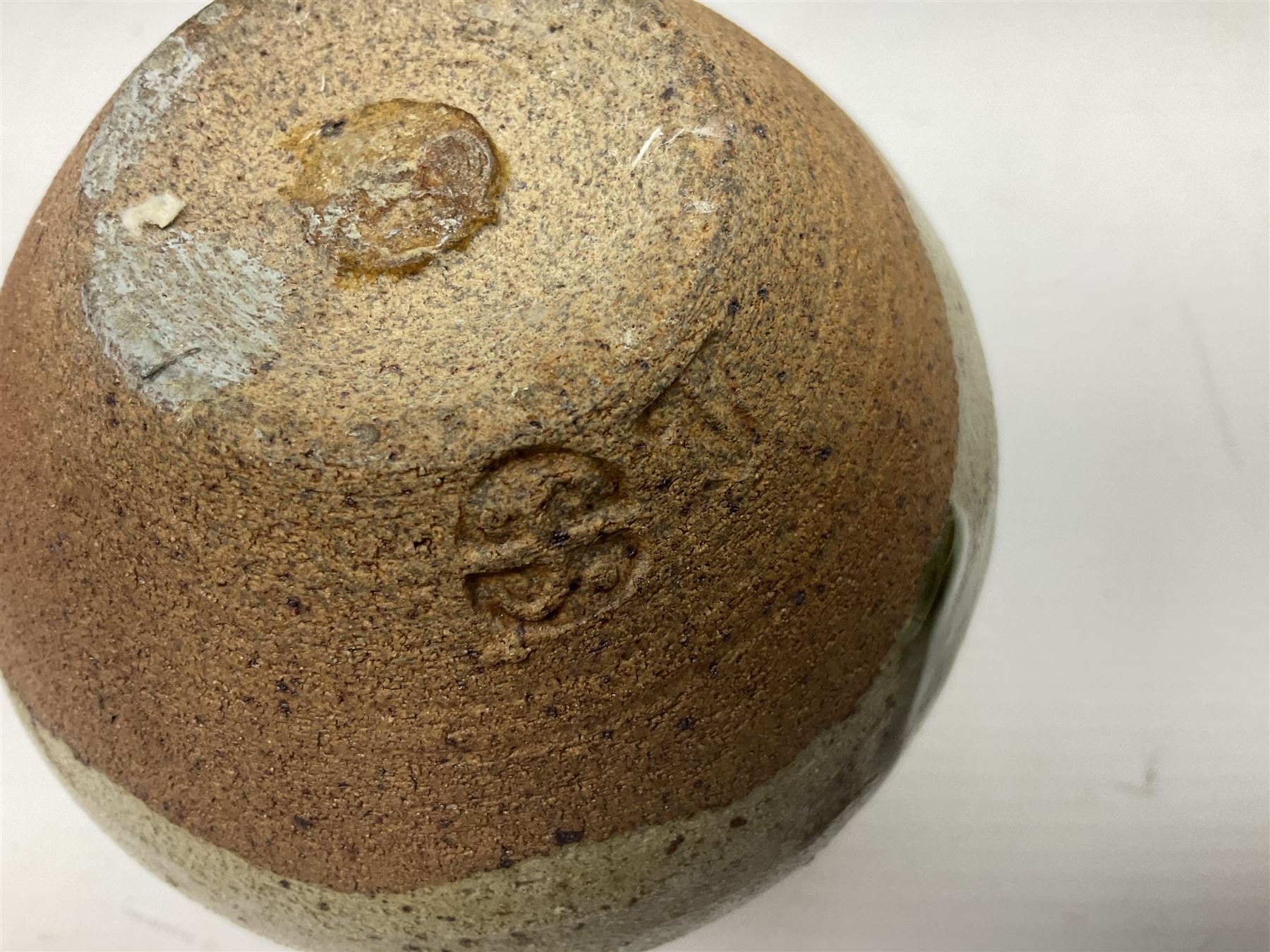 Janet Leach (American, 1918-1997) for Leach Pottery; speckled studio pottery vase of shouldered ovoid form with speckled brown decoration and trailing green and brown glaze upon beige and brown ground, with impressed J.L. monogram and Leach Pottery mark beneath, together with a Jeremy Leach blue speckled lidded circular dish with loop handle, impressed J.L, tallest H11cm
