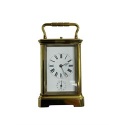 Late 19th century French carriage clock with a lever platform escapement, striking and alarm train and repeat button, in a gilt brass corniche case with an enamel dial, Roman numerals, minute track, steel moon hands and subsidiary alarm dial, eight-day movement striking the hours/half hours and alarm on two coiled gongs, movement backplate stamped G.L, trademark for Gay & Lamaille & Co, French clockmakers and wholesalers, c1880. 