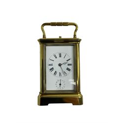 Late 19th century French carriage clock with a lever platform escapement, striking and alarm train and repeat button, in a gilt brass corniche case with an enamel dial, Roman numerals, minute track, steel moon hands and subsidiary alarm dial, eight-day movement striking the hours/half hours and alarm on two coiled gongs, movement backplate stamped G.L, trademark for Gay & Lamaille & Co, French clockmakers and wholesalers, c1880. 