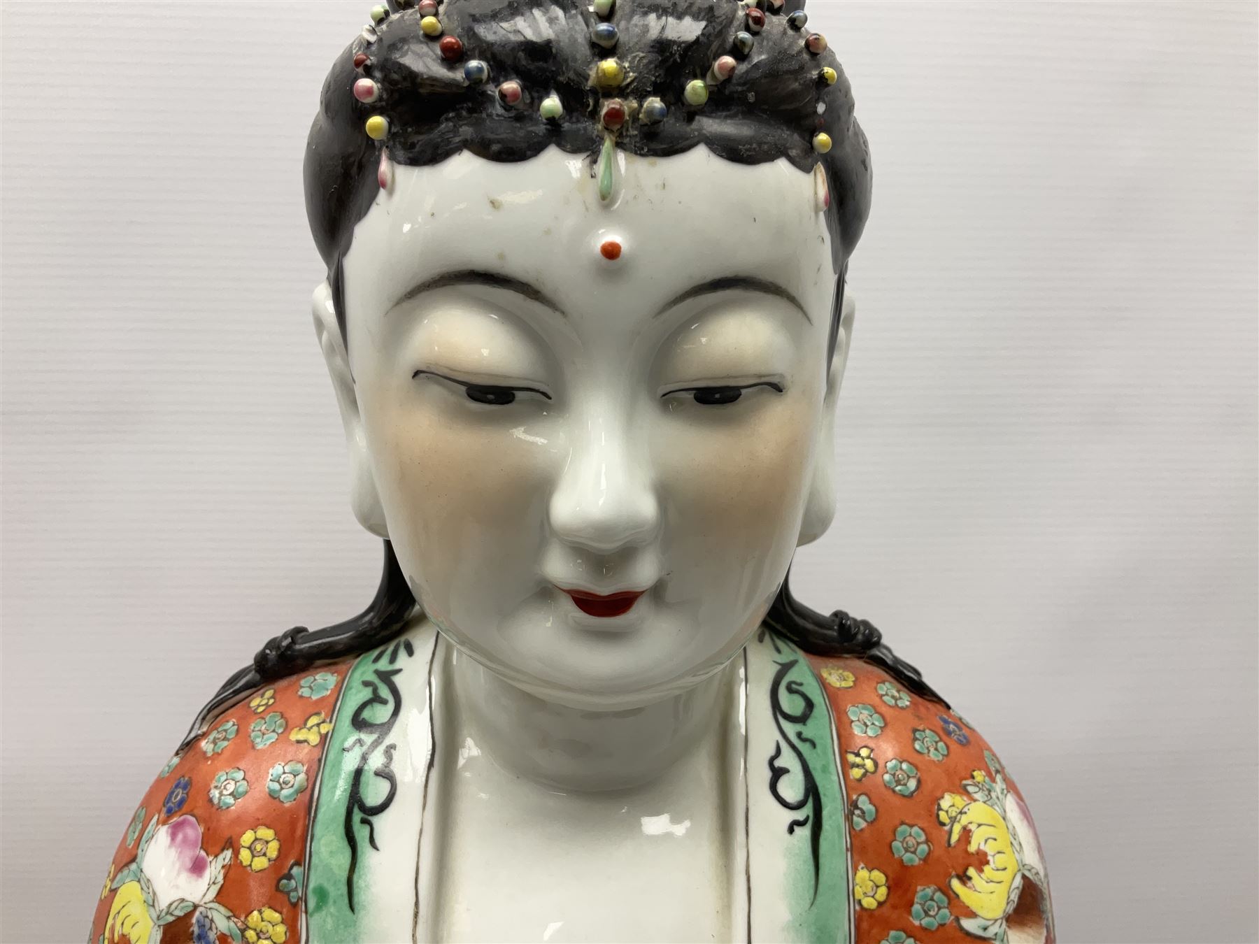 Tall Chinese polychrome figure of Guanyin (Guan Yin), the Goddess of Mercy and compassion, the Bodhisattva modelled seated and holding a rosary donning elaborate floral robes and beads, with four character seal marks beneath, H53cm