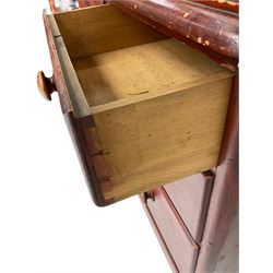 Victorian scumbled pine dressing chest, raised swing mirror in moulded frame with scrolled carved pediment, foliage S-scroll carved supports over trinket drawers, moulded rectangular top with rounded corners over two short and two long drawers, skirted base on turned feet, scumbled to resemble mahogany 