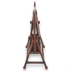 Arts and Crafts mahogany magazine stand, in the manner of Christopher Dresser, folding magazine stand, rectangular divided slatted compartments with turned spindle galleries and ball finials, the sides forming an X-frame action, raised on turned supports united by stretchers