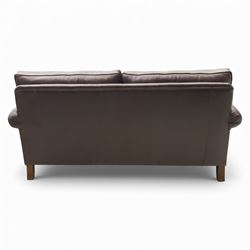 Laura Ashley - brown leather two seater sofa, loose cushion back and seat, flanked by scrolled arms upon light stained wood supports on castors