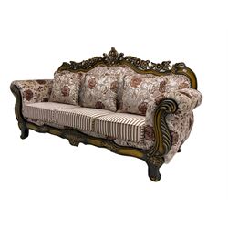 Italian Baroque design three seat sofa, hardwood framed, the cresting rail carved and pierced with c-scrolls and flower heads, scrolled arms, upholstered in floral patterned and striped fabric, with scatter cushions 