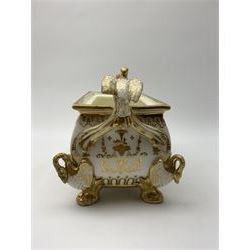 19th century Coalport bough pot, circa 1820, of bombe form, the body with twin handles surmounted by two birds and raised upon four feet modelled as swans, hand painted with two panels depicting an urn of flowers set against a mountainous landscape, the whole heightened in gilt throughout, H13cm L21cm