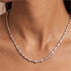 18ct white gold diamond necklace, bezel set with a single round brilliant cut diamond, spaced by two further diamonds, to a rectangular link necklace, London 2000, total diamond weight approx 0.75 carat