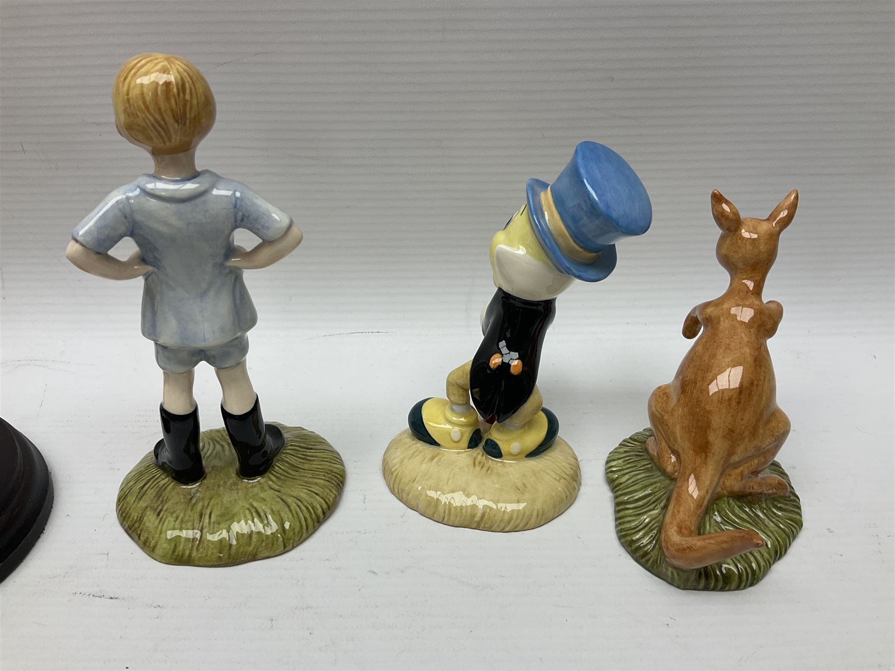 Nine Royal Doulton Winnie the Pooh Collection figures, including Oh Dear Bath Time's Here, Going Sledging, Tigger's Splash Time and Christopher Robin, together with a Royal Doulton Disney Showcase Jiminy Cricket figure, all boxed