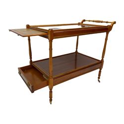 Yew wood drinks trolley, rectangular form with leather inset slide and turned handle, the undertier fitted with drawer, turned supports and brass castors