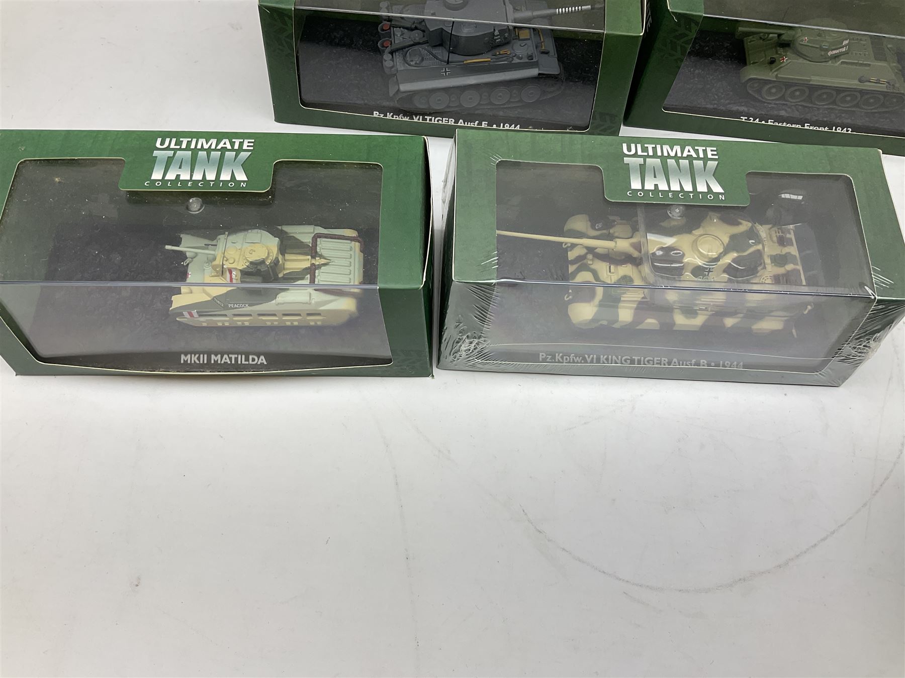 Sixteen Atlas Editions die-cast models of military vehicles including six Ultimate Tank Collection; all in perspex display cases; fourteen boxed; with associated paperwork (16)