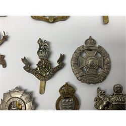Twenty cap badges including Hertfordshire, Royal Sussex, Cambridgeshire, Hampshire, Notts and Derby, East Surrey, Herefordshire, South Lancashire, Devonshire, Bedfordshire, Durham Light Infantry etc (20)