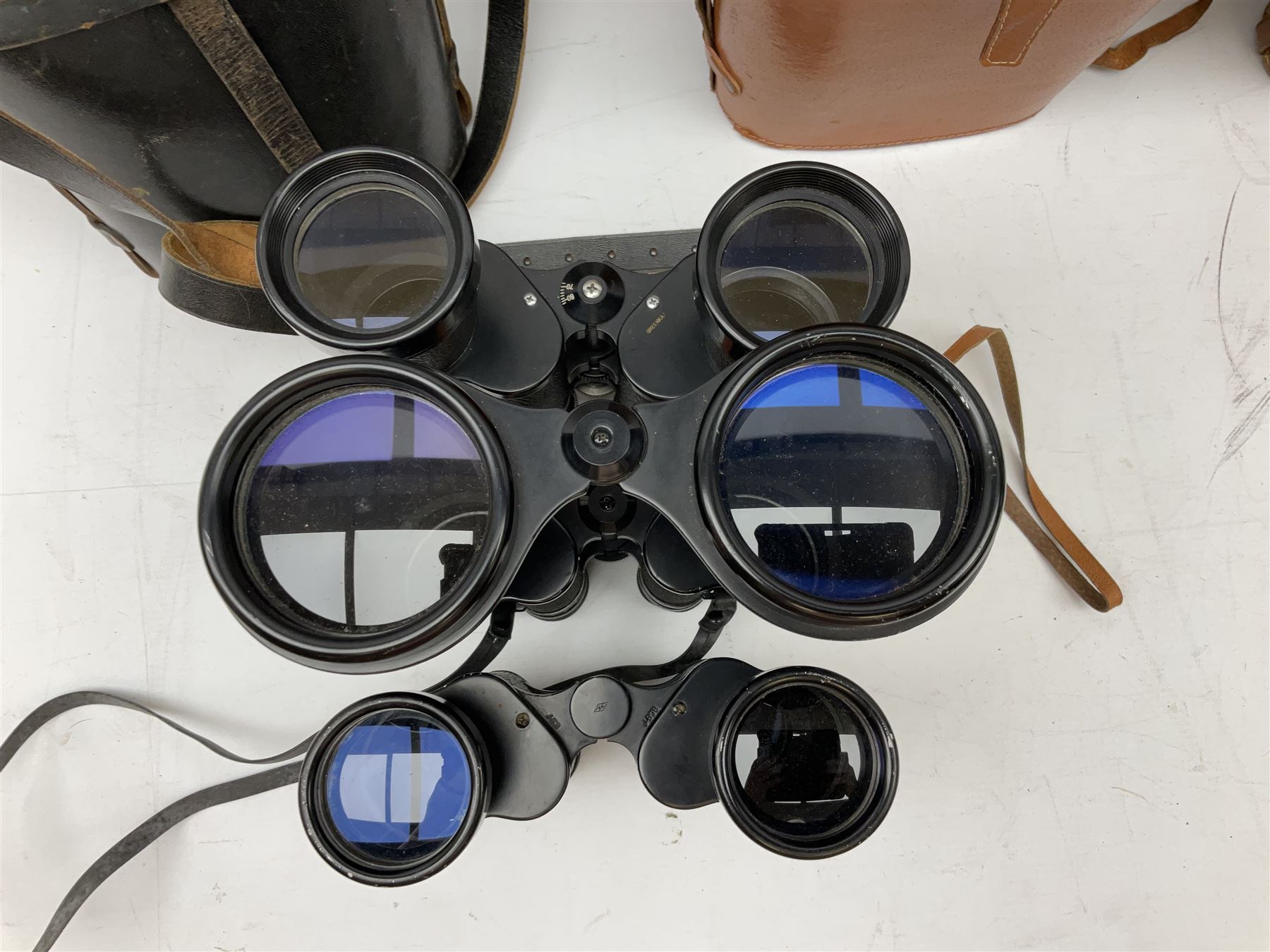 Nine cased pairs of binoculars, to include Tohyoh 22x70, Greenkat 7x- 12x50, Chinon, Fisher-Dietz 7x50, etc