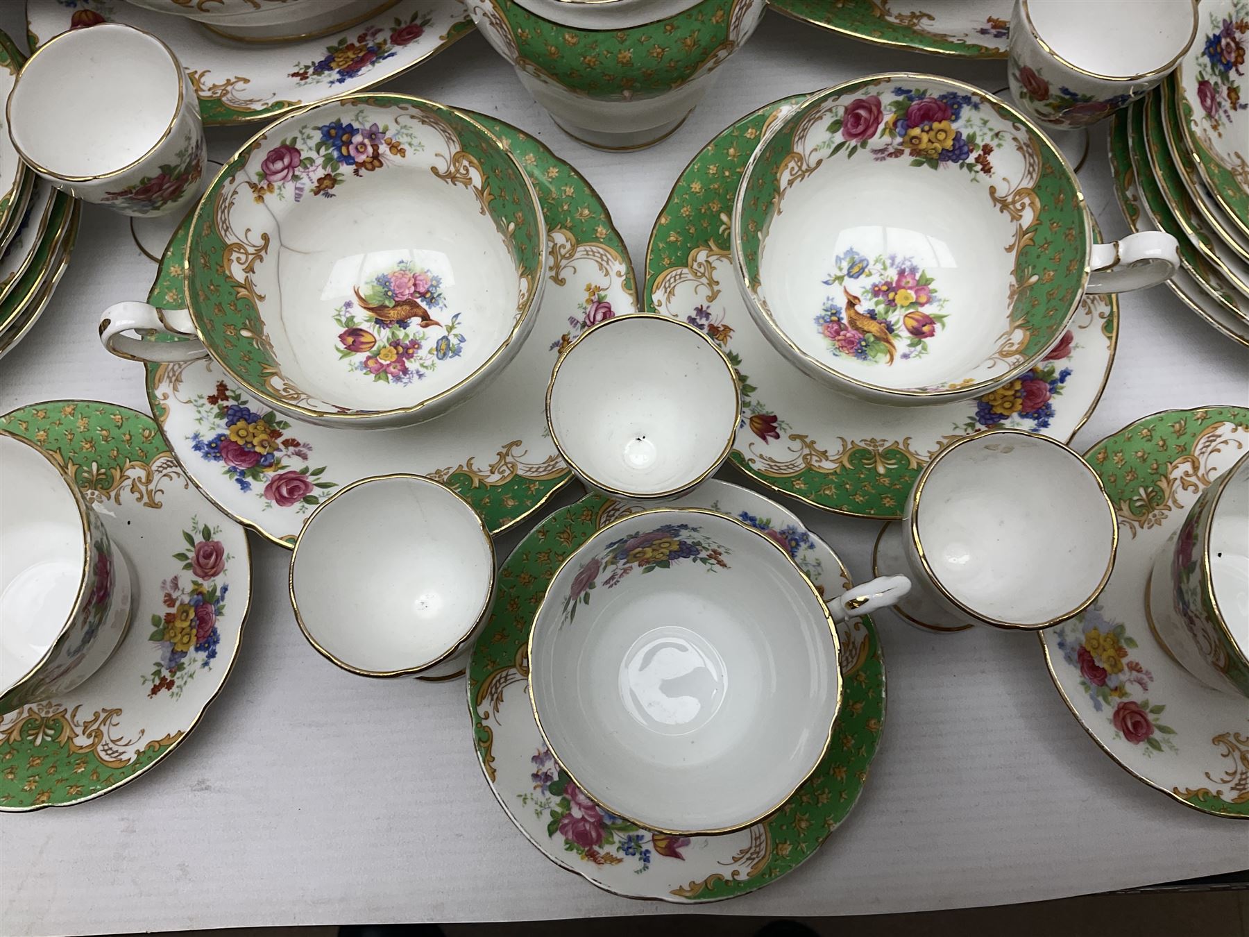Paragon Rockingham pattern part tea and dinner service including three teapots, milk jug, cups and saucers of various sizes, ten soup bowls, ten side plates, ten dinner plates etc (96)