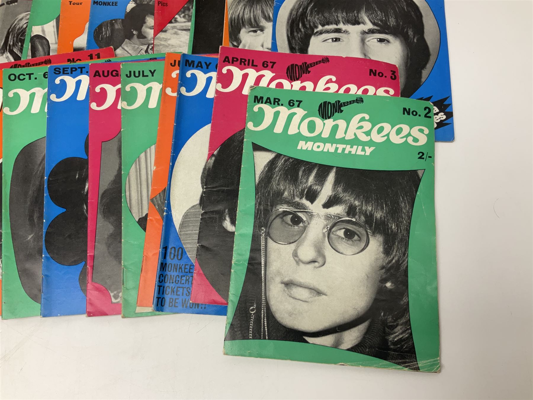 Monkees memorabilia - 'Monkees Monthly' magazine almost complete run from No.1 Feb 67 to No.31 Aug 69 (lacking nos.29 and 32); the cover of No.1 signed by all four members of the group during their 1997 Reunion Tour; quantity of A&BC bubble gum cards; programme for their only UK live performance in 1967 at Empire Pool Wembley; and other related late 1960s music magazines/paperback book