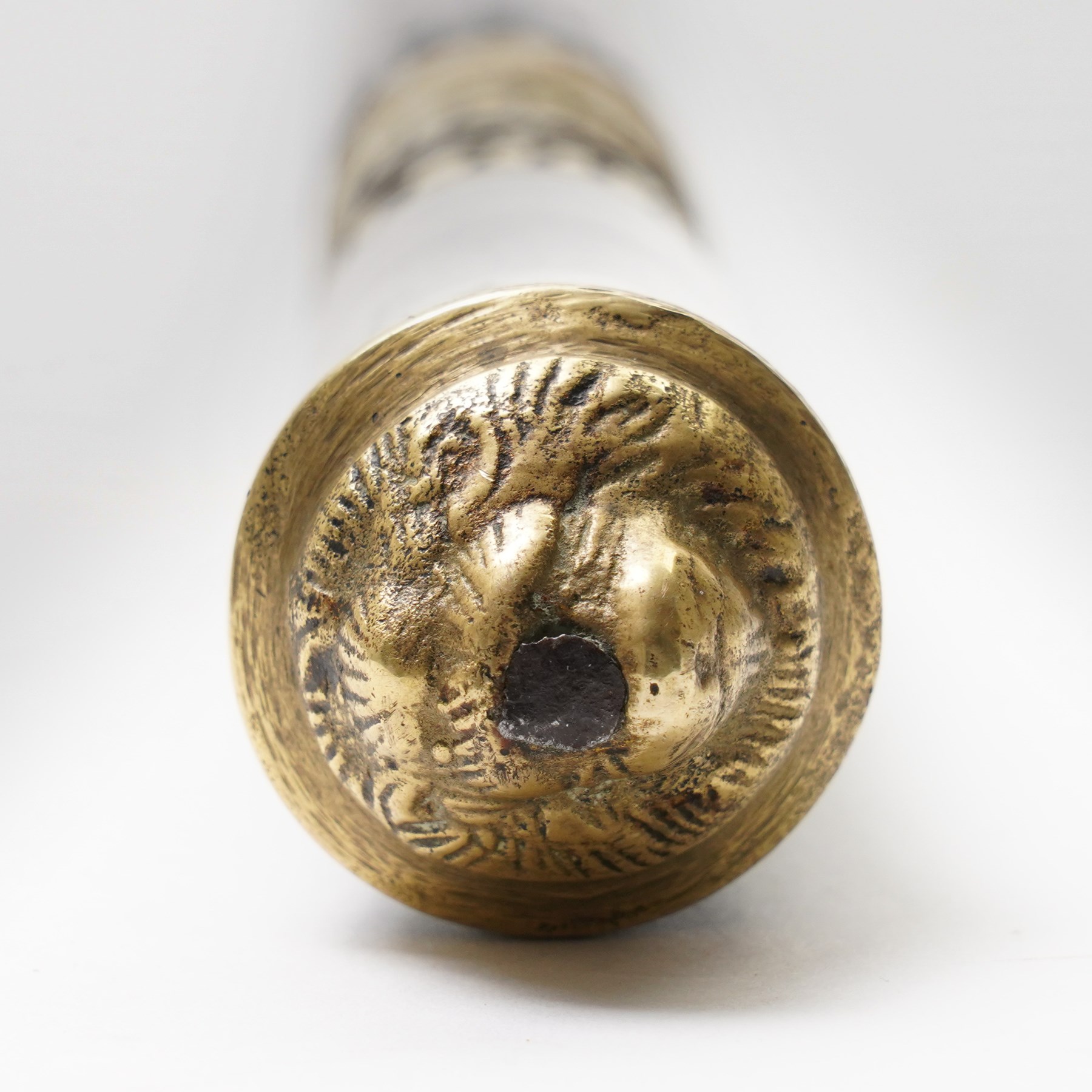 Early 20th century Indian concealed sword-stick, the black wooden scabbard and grip with carved bone collar, engraved brass band, and brass pommel in the form of a tigers head, W92cm