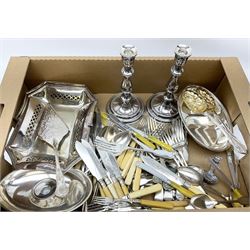 Collection of silver plated ware and other metal ware, including a pair of candle sticks, basket with handle, a collection of flatware including serving spoons, forks, knives etc. 
