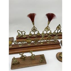 Brass horse terrets, many mounted on wood, including four examples with plumes