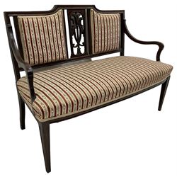 Edwardian mahogany framed three-piece salon suite - two-seat sofa, stepped cresting rail over acanthus and scroll carved pierced splat, upholstered in striped fabric (W124cm, H87cm, D62cm); and a pair of matching armchairs (W60cm) 
